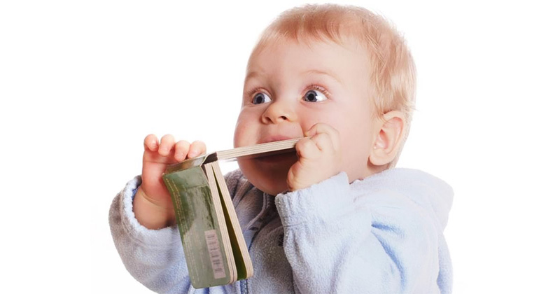child is eating a book