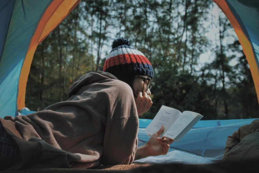 women reads in a tent
