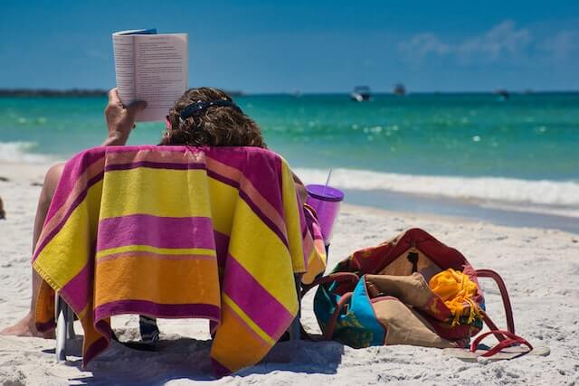 women is reading the beach